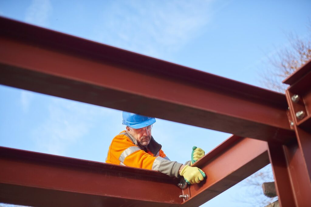 worker taking care of metal structure